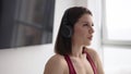 Woman doing stretching warmup in headphones