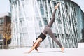 Woman doing stretching yoga exercises outside in the city Royalty Free Stock Photo