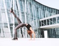 Woman doing stretching yoga exercises outside in the city Royalty Free Stock Photo