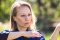 A girl doing tai Chi exercises in a green Park on a Sunny day close up Royalty Free Stock Photo