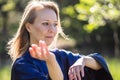 A girl doing tai Chi exercises in a green Park on a Sunny day close up Royalty Free Stock Photo