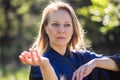 A girl doing tai Chi exercises in a green Park on a Sunny day close up Royalty Free Stock Photo