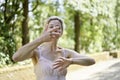 Woman doing relaxing exercises with her arms in a park