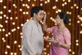 Woman doing tilak of her husband on Diwali