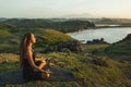Woman doing yoga alone at sunrise with mountain view. Harmony with nature Royalty Free Stock Photo