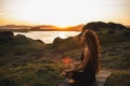 Woman doing yoga alone at sunrise with mountain view. Harmony with nature Royalty Free Stock Photo