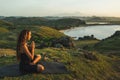 Woman doing yoga alone at sunrise with mountain view. Harmony with nature