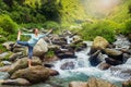 Woman doing yoga asana Natarajasana outdoors at waterfall Royalty Free Stock Photo