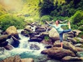 Woman doing yoga asana Natarajasana outdoors at waterfall Royalty Free Stock Photo