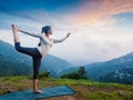 Woman doing yoga asana Natarajasana outdoors at waterfall Royalty Free Stock Photo