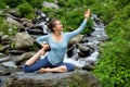 Woman doing yoga asana at tropical waterfall Royalty Free Stock Photo