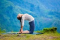 Woman doing yoga asana Ustrasana camel pose outdoors Royalty Free Stock Photo