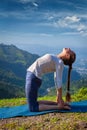 Woman doing yoga asana Ustrasana camel pose outdoors Royalty Free Stock Photo