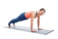 Woman doing yoga asana Utthita chaturanga dandasana (or phalakasana) Royalty Free Stock Photo