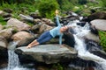 Woman doing yoga asana Vasisthasana - side plank pose outdoors Royalty Free Stock Photo