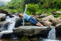 Woman doing yoga asana Vasisthasana - side plank pose outdoors