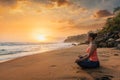 Woman doing yoga at beach - Padmasana lotus pose