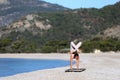 Woman doing yoga on the beach, handstand Royalty Free Stock Photo