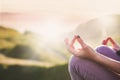 woman doing yoga in beautiful nature background at sunset or sunrise, focus on hand - mindfulness and mental health and hygiene Royalty Free Stock Photo