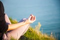 woman doing yoga in beautiful nature background at sunset or sunrise, focus on hand - mindfulness and mental health and hygiene Royalty Free Stock Photo