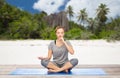 Woman doing yoga breathing exercise on beach Royalty Free Stock Photo