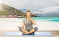 Woman doing yoga breathing exercise on beach Royalty Free Stock Photo