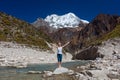 Woman is doing yoga excercises near big lake on the Manaslu circuit trak in Nepala Royalty Free Stock Photo