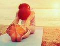 Woman doing yoga exercise on beach