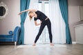 Woman doing yoga exercise at home. Morning workout in bedroom. Healthy and sport lifestyle. Royalty Free Stock Photo