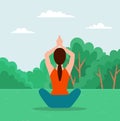 Woman doing yoga exercise. Young fit girl sitting in lotus position on the grass in city park Royalty Free Stock Photo