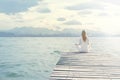 Woman doing yoga exercises in front of a spectacular scenery