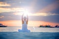 A woman is doing yoga exercises at the sunset on Boracay island, Philippines Royalty Free Stock Photo