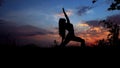 Woman doing yoga, female silhouette in evening sky background. Royalty Free Stock Photo
