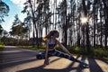 Woman Doing Yoga in forest Against Sky and Sun. Hard light. Silhouette of girl doing outdoor sport stretch Royalty Free Stock Photo