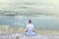 Woman doing yoga in front of a spectacular mountain lake Royalty Free Stock Photo