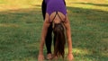 Woman doing yoga on green grass