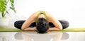 Woman doing yoga on the green yoga mat for meditite and excercise in the home Royalty Free Stock Photo