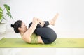 Woman doing yoga on the green yoga mat for meditite and excercise in the home Royalty Free Stock Photo