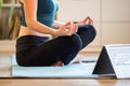 woman doing yoga at home watching online videos Royalty Free Stock Photo