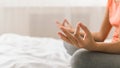 Woman doing yoga lotus pose on bed after wake up Royalty Free Stock Photo