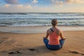 Woman doing yoga oudoors at beach - Padmasana lotus pose Royalty Free Stock Photo