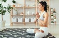 Woman doing yoga, meditating in Lotus position at home Royalty Free Stock Photo