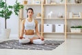 Woman doing yoga, meditating in Lotus position at home Royalty Free Stock Photo