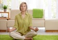 Woman doing yoga meditation at home