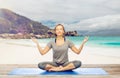 Woman doing yoga meditation in lotus pose on beach Royalty Free Stock Photo