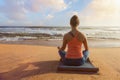 Woman doing yoga oudoors at beach - Padmasana lotus pose Royalty Free Stock Photo