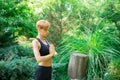 Woman doing yoga in the park, young girl doing various wellness exercises