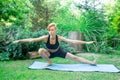 Woman doing yoga in the park, young girl doing various wellness exercises