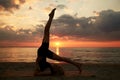 woman doing yoga shoulderstand on beach Royalty Free Stock Photo