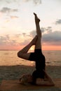 woman doing yoga shoulderstand on beach Royalty Free Stock Photo